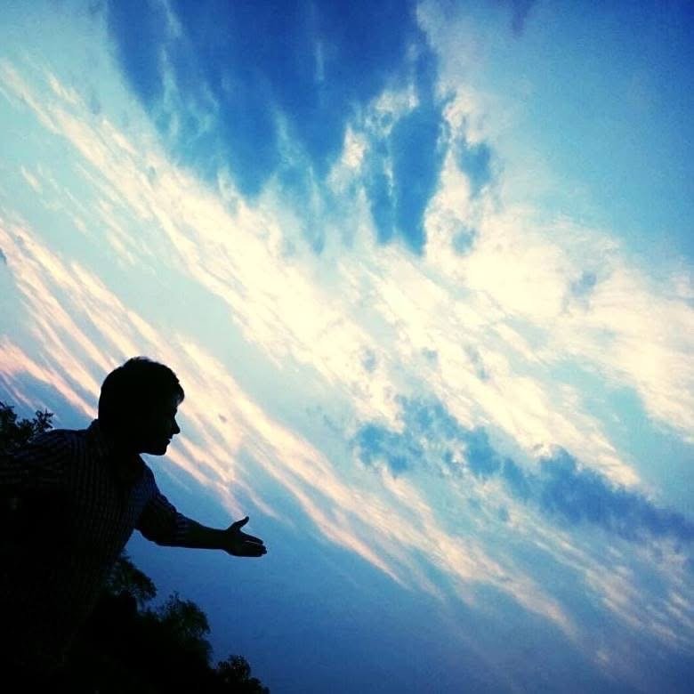 Nazrul in silhouette beneath a dramatic sky